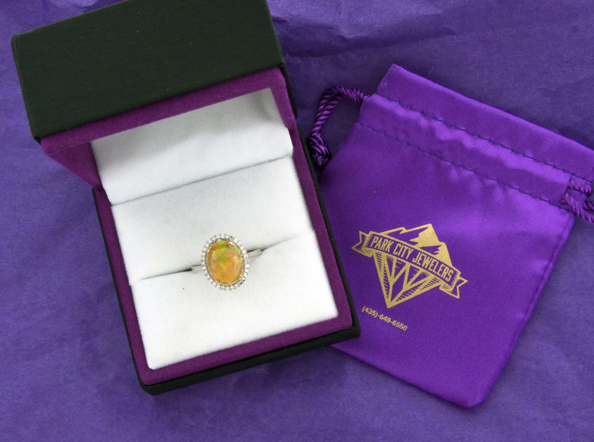 Oval Ethiopian Opal and Diamond Halo Ring